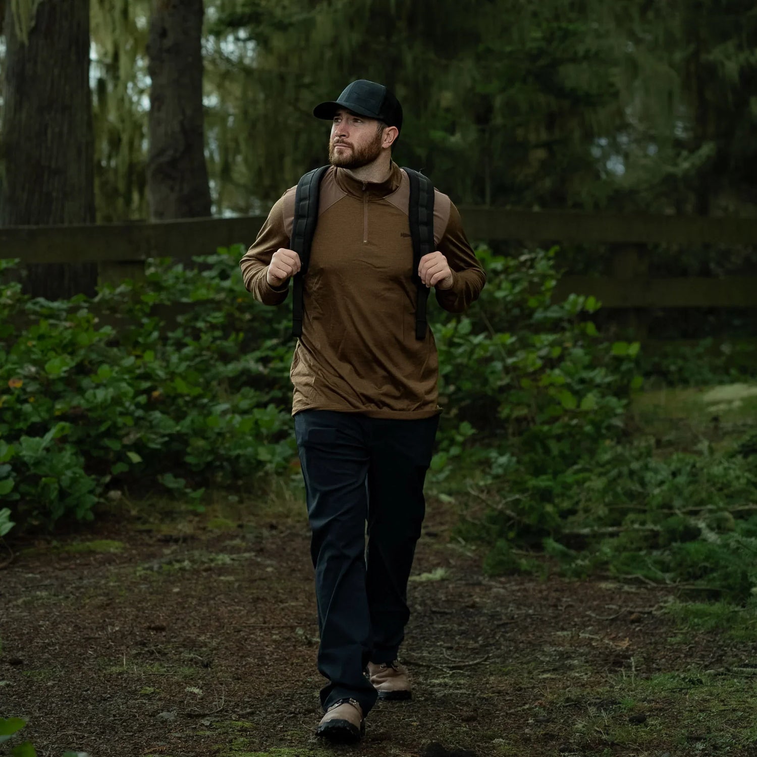 Man rucking with GORUCK backpack in forest, outdoor training gear, rugged trail setting