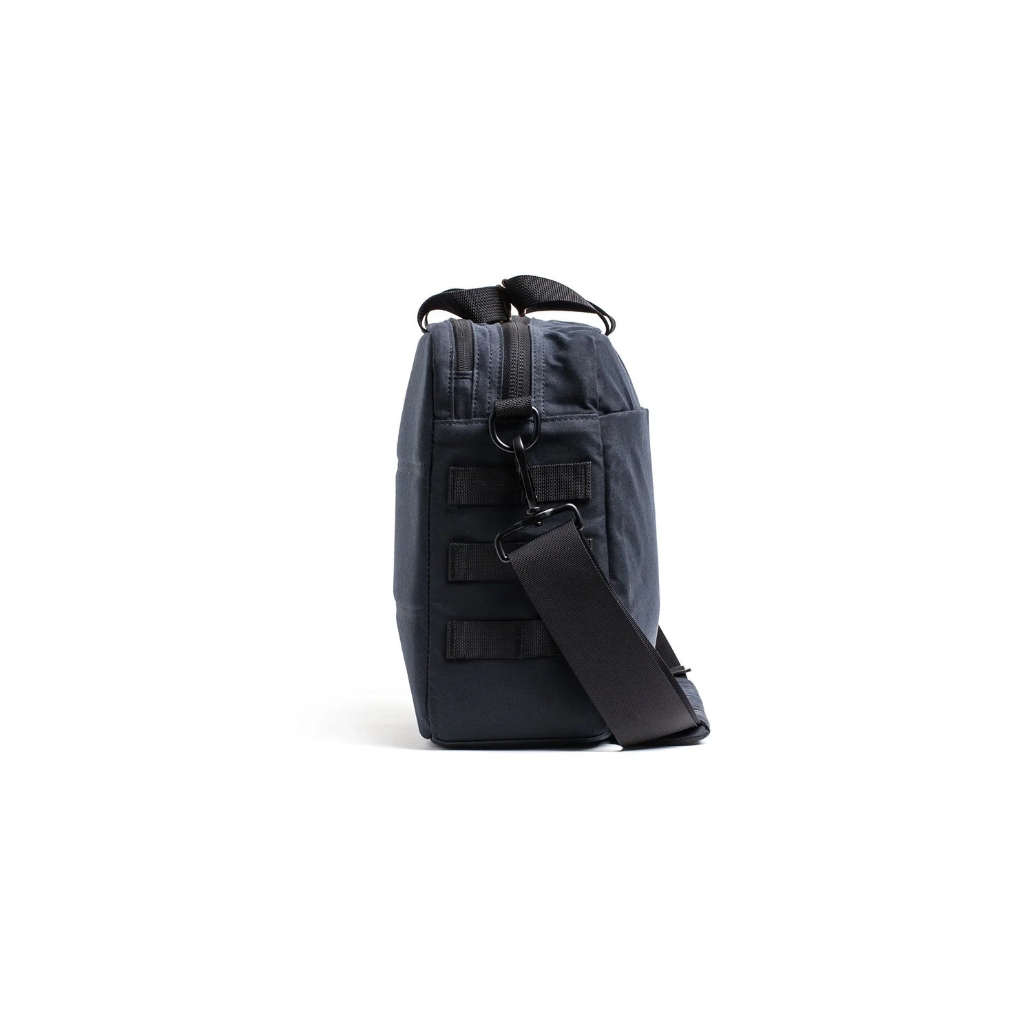 Side view of a black GORUCK 15L Heritage shoulder bag with adjustable strap on white background