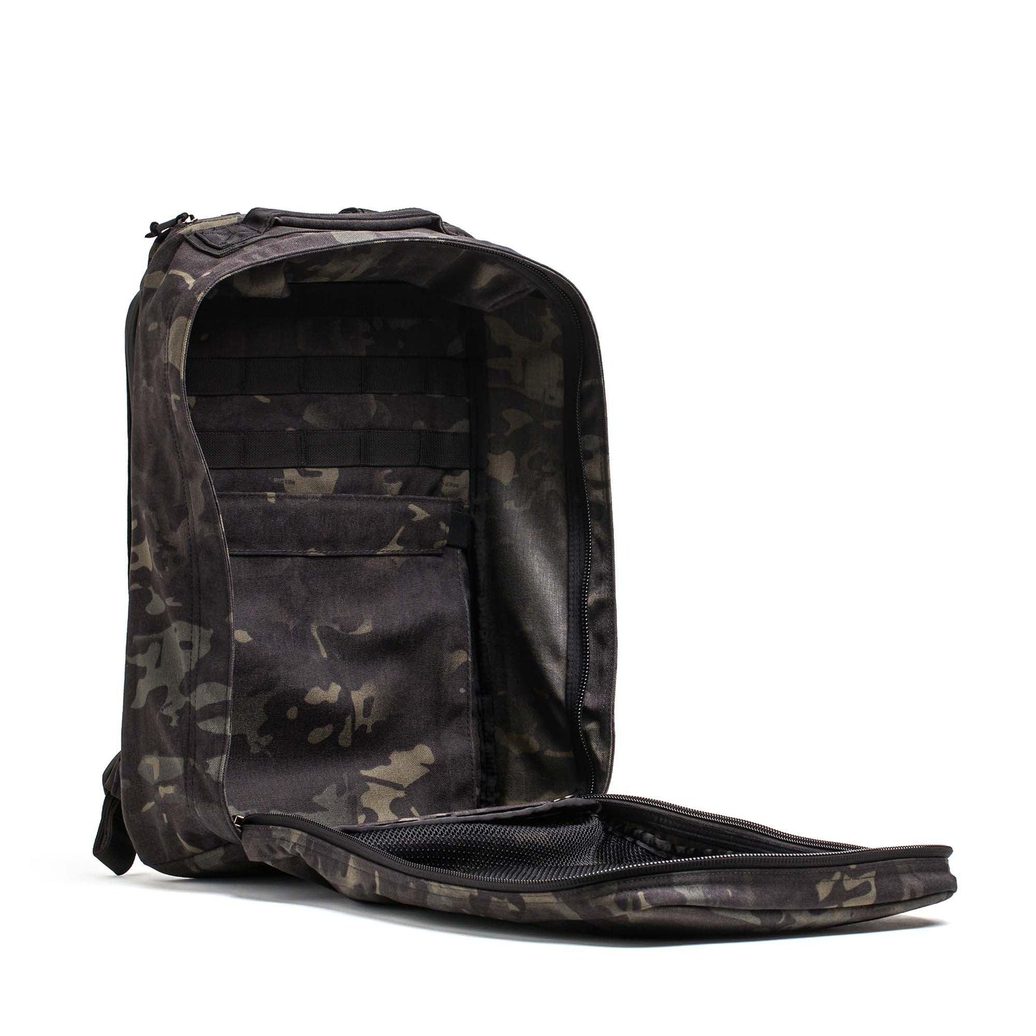 A black GR1 USA Slick - Ballistic Nylon Cordura backpack is unzipped, showing its roomy interior, inner pockets, and bombproof laptop compartment.
