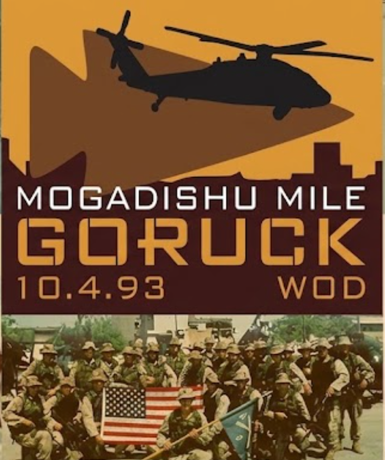 Soldiers pose with the American flag as a helicopter silhouette hovers above; text reads “CITY RUCK - TAMPA w/ RUCKAPALOOZA Fitness Festival MOG MILE Anniversary @ NOEQL TRAINING CO.,” commemorating the Black Hawk Down Anniversary.