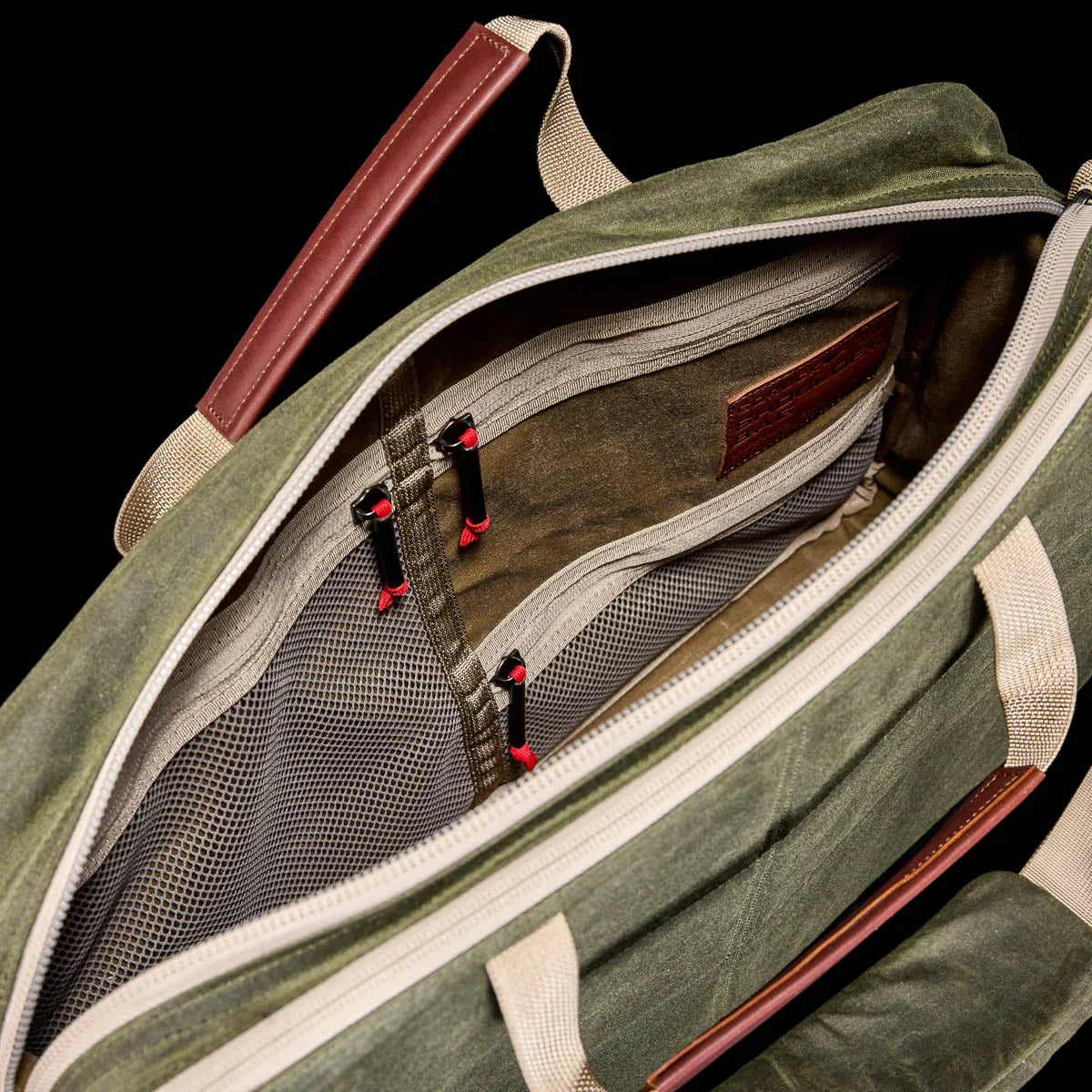 GORUCK olive field waxed canvas shoulder bag with tan leather handles and spacious zippered interior pockets