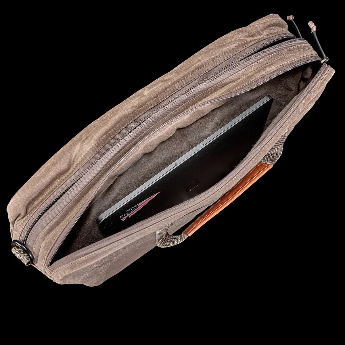 Top view of GORUCK dark oak waxed canvas shoulder bag with padded laptop compartment and American flag sticker
