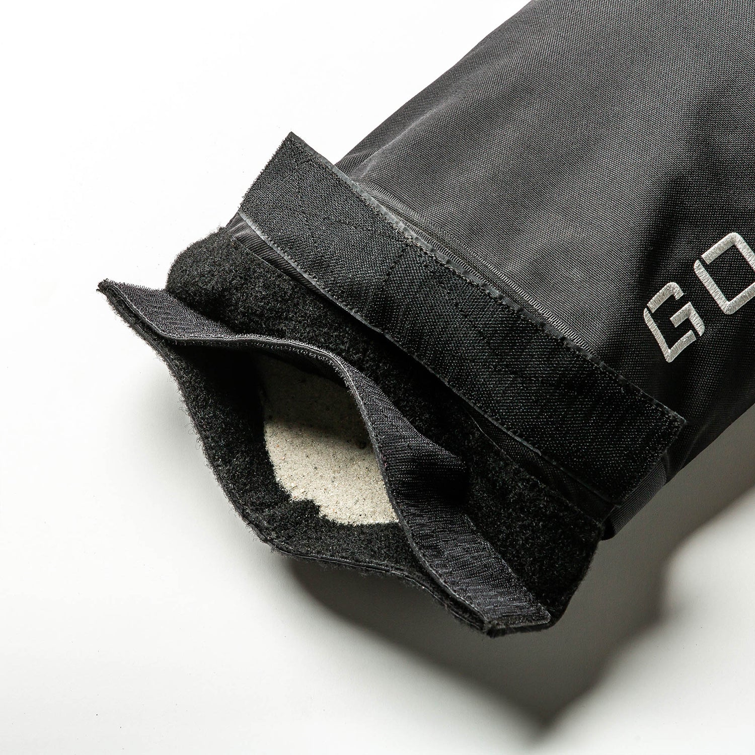 Close-up of a black glove with Velcro strap and soft fleece lining—ideal for gripping Simple Training Sandbags or other home gym equipment.