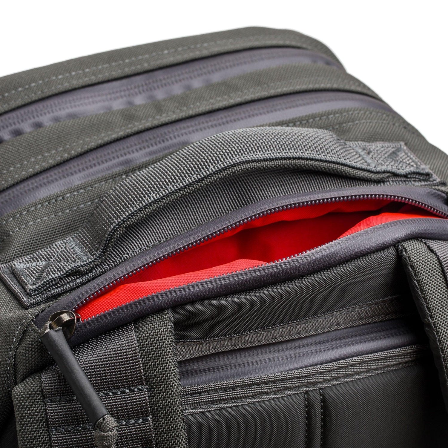 GORUCK grey rucksack close-up, durable fabric, red interior, rugged zipper detail