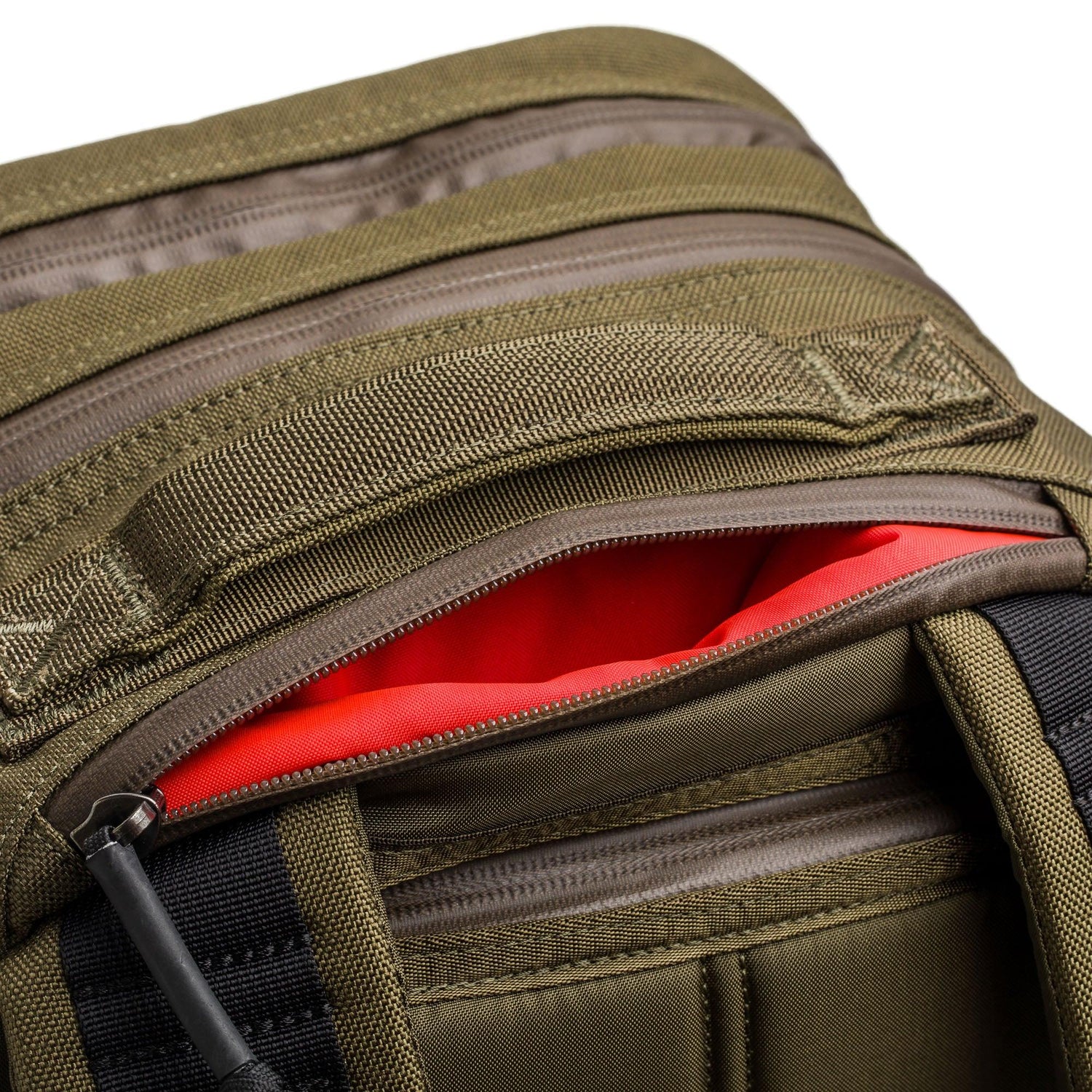 GORUCK green rucksack close-up with rugged zippers and red interior pocket