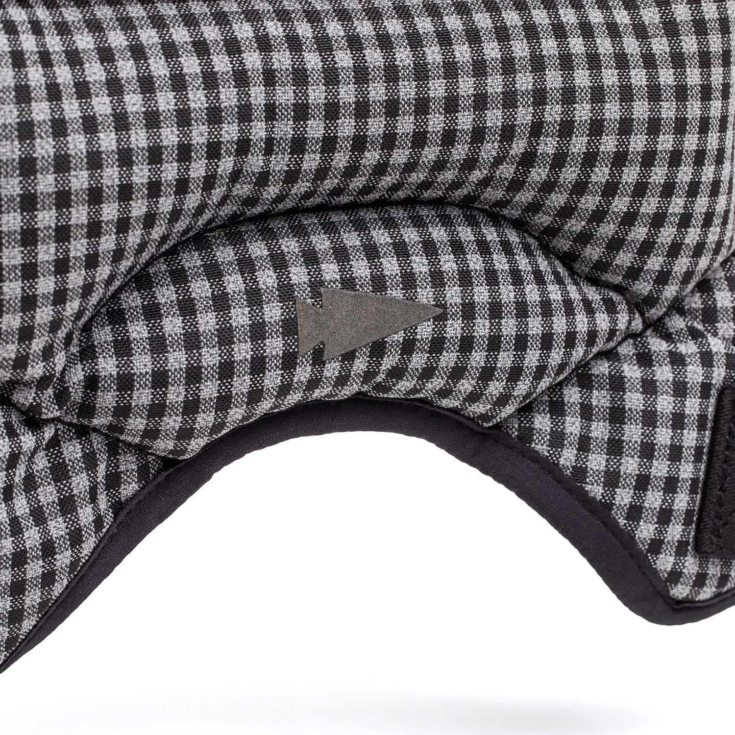 Close-up of a black-and-white checkered cushion with a gray arrow, inspired by the durable design of the Spy Ruck Women's Weighted Vest.