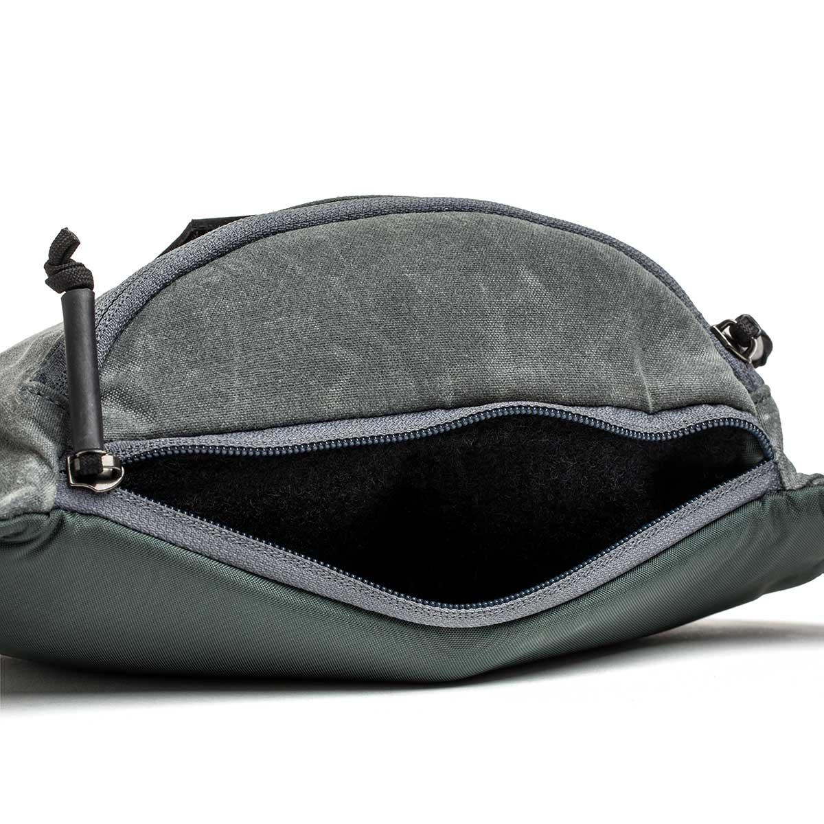 GORUCK tactical fanny pack in slate waxed canvas with open zipper and spacious interior