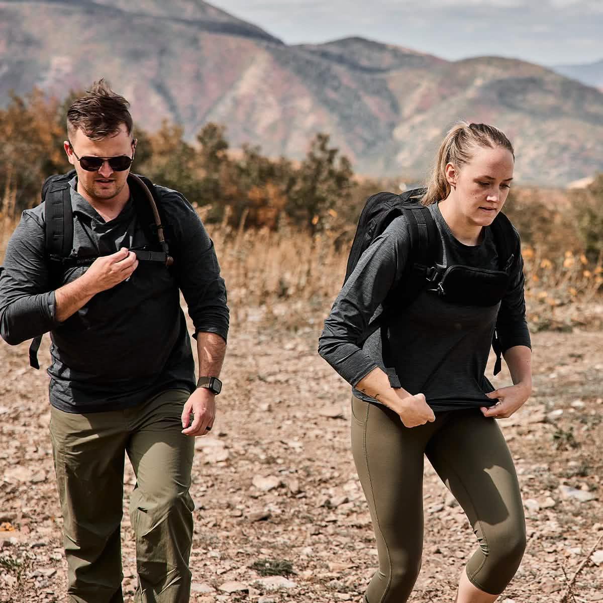 Two people rucking outdoors in GORUCK ToughMesh charcoal shirts and backpacks on a trail