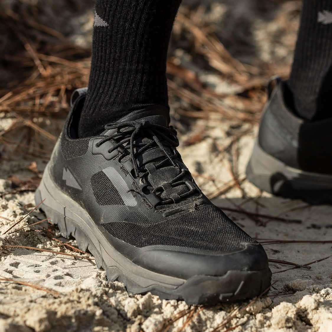 GORUCK black rucking shoe on sandy outdoor trail, close-up for durability and performance