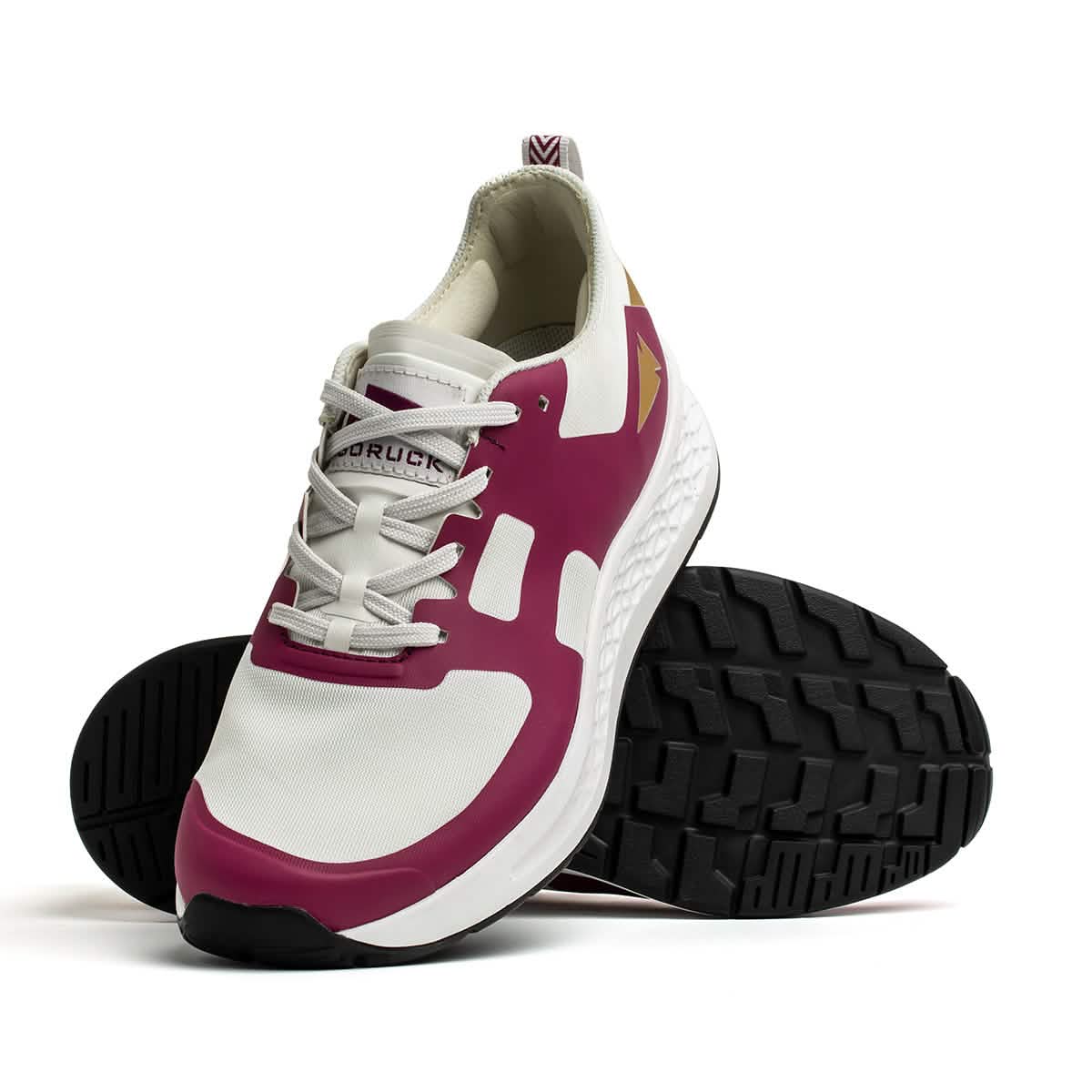 The Men's Rough Runner - Baton Rouge by GORUCK is showcased against a white backdrop, featuring a modern design. This athletic shoe displays magenta accents on the sides, a textured white sole, and black tread with gradient density. It is positioned to highlight both the side and sole views.