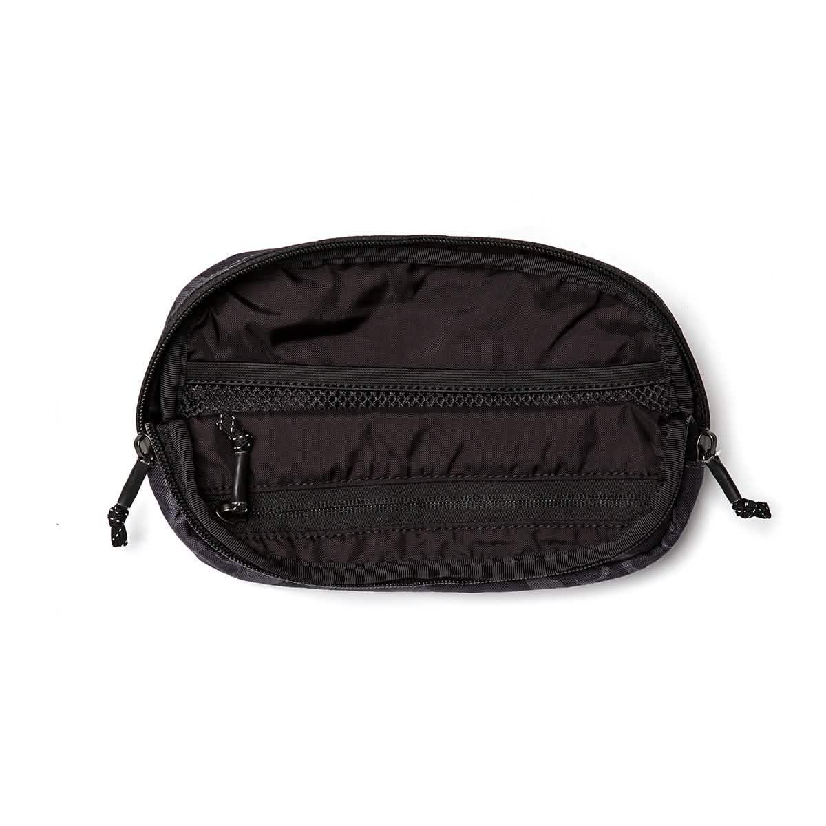 Open black GORUCK belt bag showing internal zippered mesh and fabric compartments
