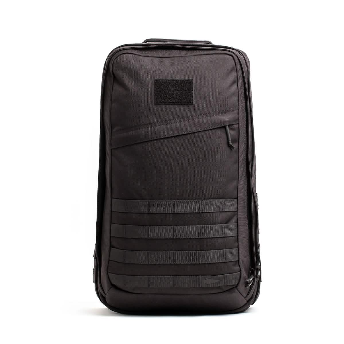 Black GORUCK tactical rucksack with MOLLE webbing and diagonal zippered pocket on white background