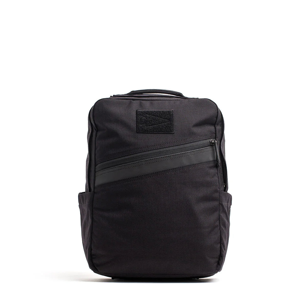 The KR1 2.0 - Kid Ruck is a black kids backpack with a diagonal front zipper, top handle, side pockets, and a simple rectangular shape—an indestructible school bag made for daily adventures. Add patches to make it yours!.