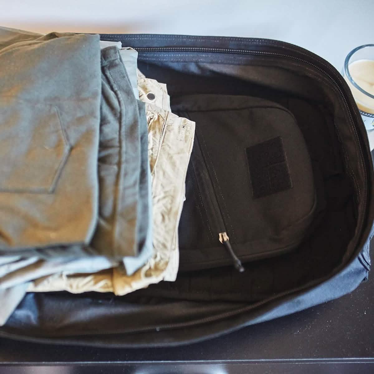 GORUCK rucksack open with folded pants and gear neatly packed inside