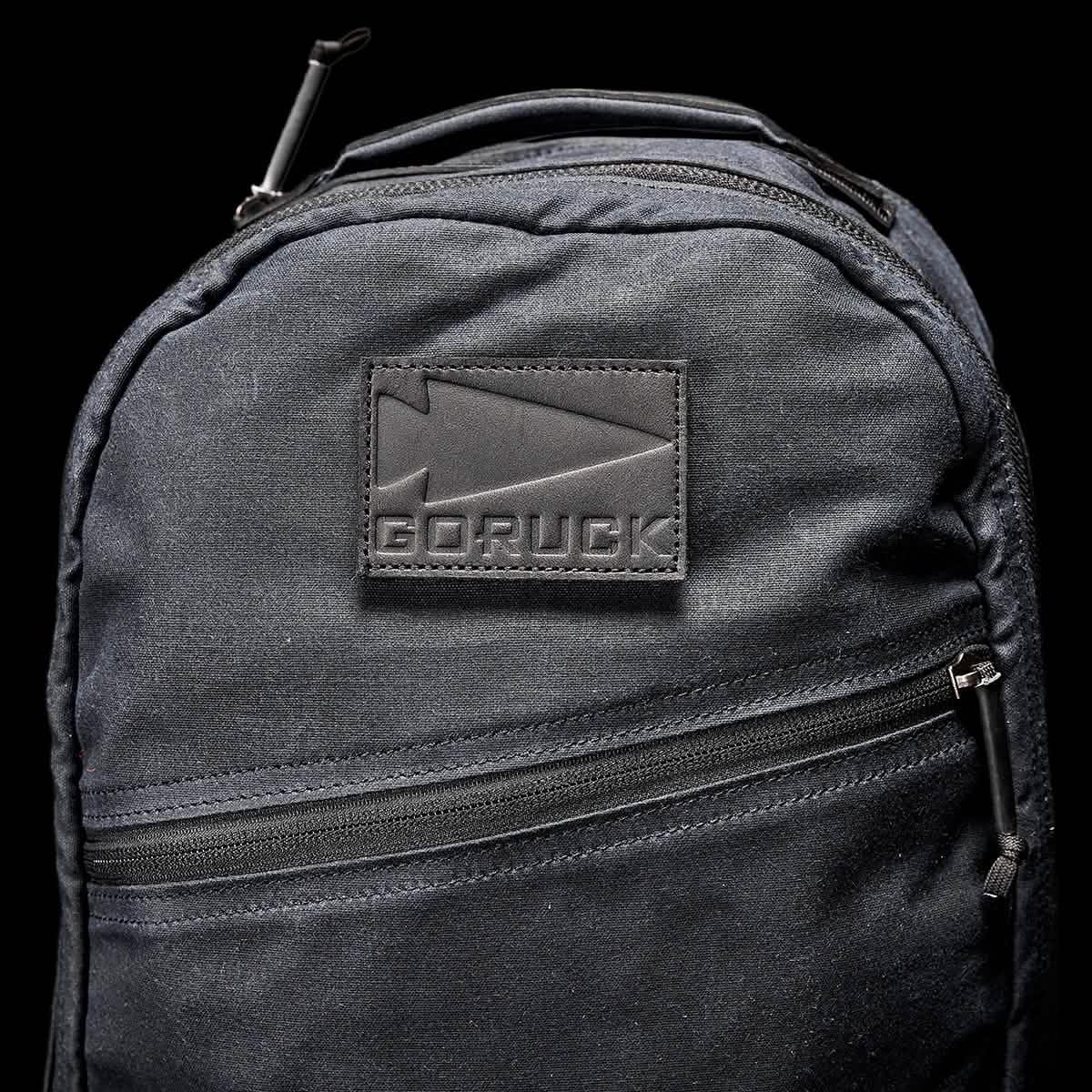 Close-up of black GORUCK Bullet Waxed 16 backpack with durable fabric and front zipper pocket