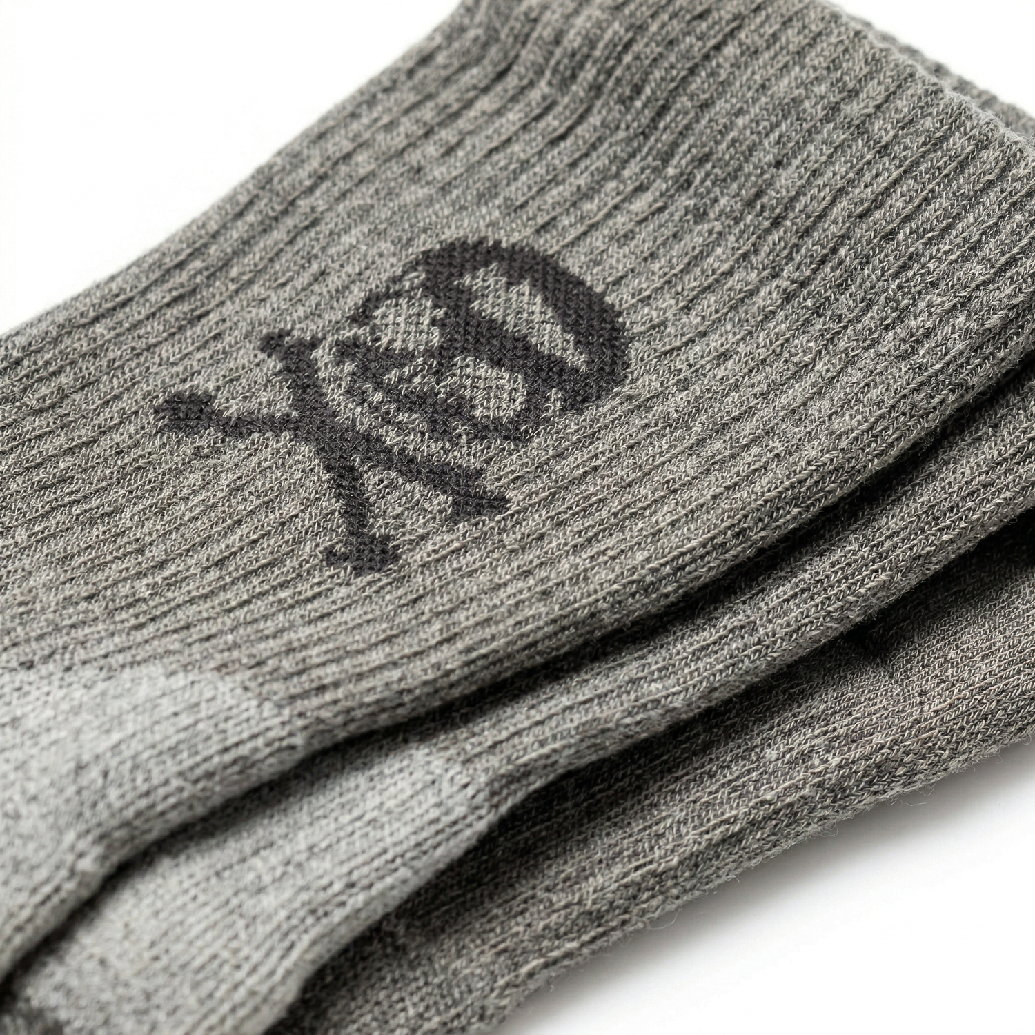 Tribe Merino Challenge Socks - Crew: gray crew socks featuring a black skull and crossbones design near the top, crafted for comfort and style—perfect for fans of the best wool socks.