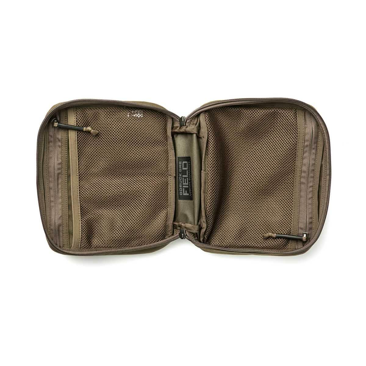 The GR2 Field Pocket by GORUCK is a khaki-colored electronics organizer made from durable 1000D Cordura. It features an open zipper design and includes two mesh compartments on each side. When laid flat, it provides ample space for organizing items, with zippers on both compartments ensuring secure storage.