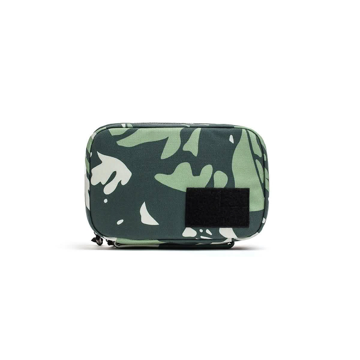 The GR1 Field Pocket - USA is a camouflage-patterned rectangular pouch with a black front patch, ideal as a dopp kit or electronics organizer, shown on a white background.