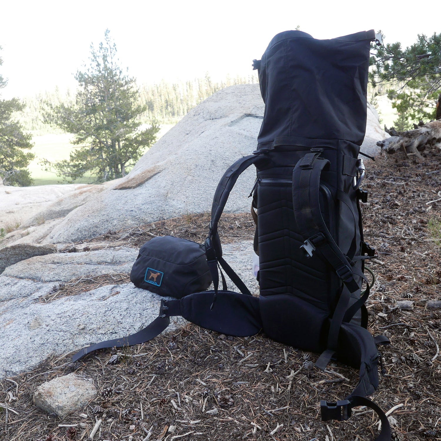 The GR MONSTER Bundle - PREORDER stands on rocky ground with trees and sunlight in the background.