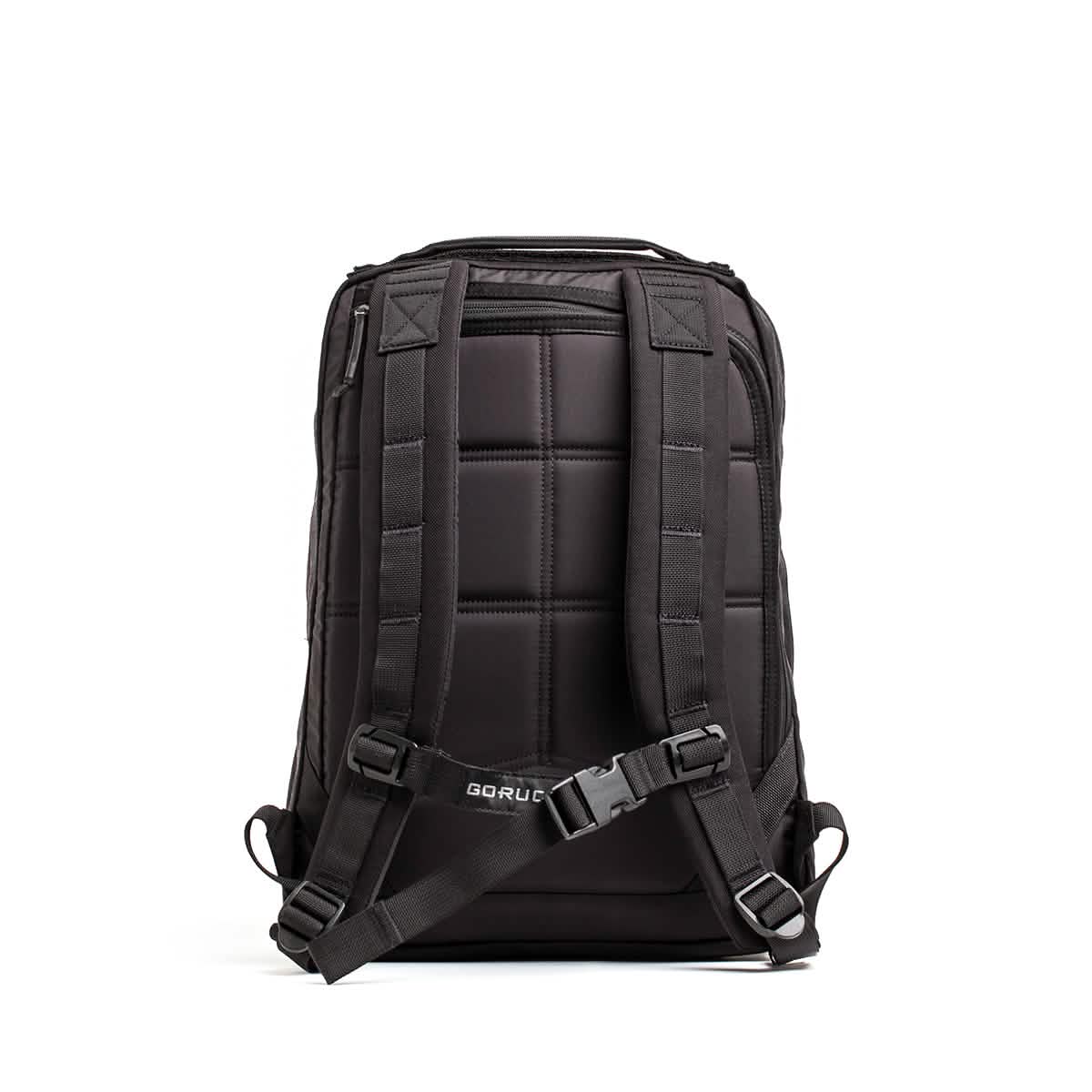 Displayed on a simple white backdrop is the GR0 - Cordura, a sleek black backpack featuring a bombproof laptop compartment, padded shoulder straps, and a sternum strap. Its cushioned back panel ensures comfort, while the GORUCK logo at the bottom highlights its status as an ideal minimalist EDC selection.