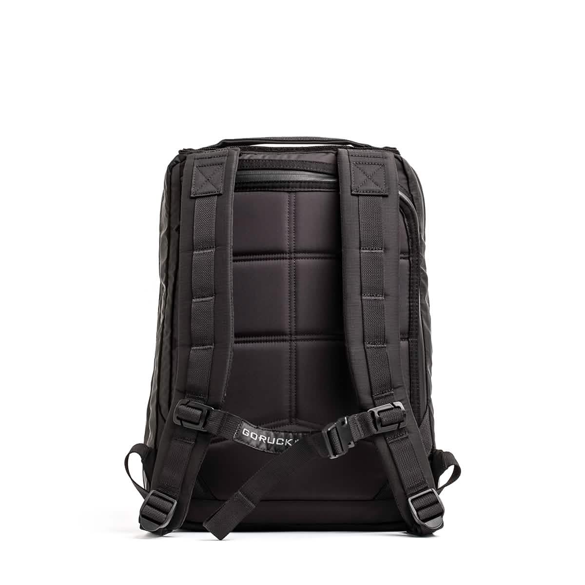 The GR0 - Ripstop ROBIC® backpack, shown from the back with padded straps and a chest buckle, is a black, water-resistant minimalist everyday carry displayed against a white background.