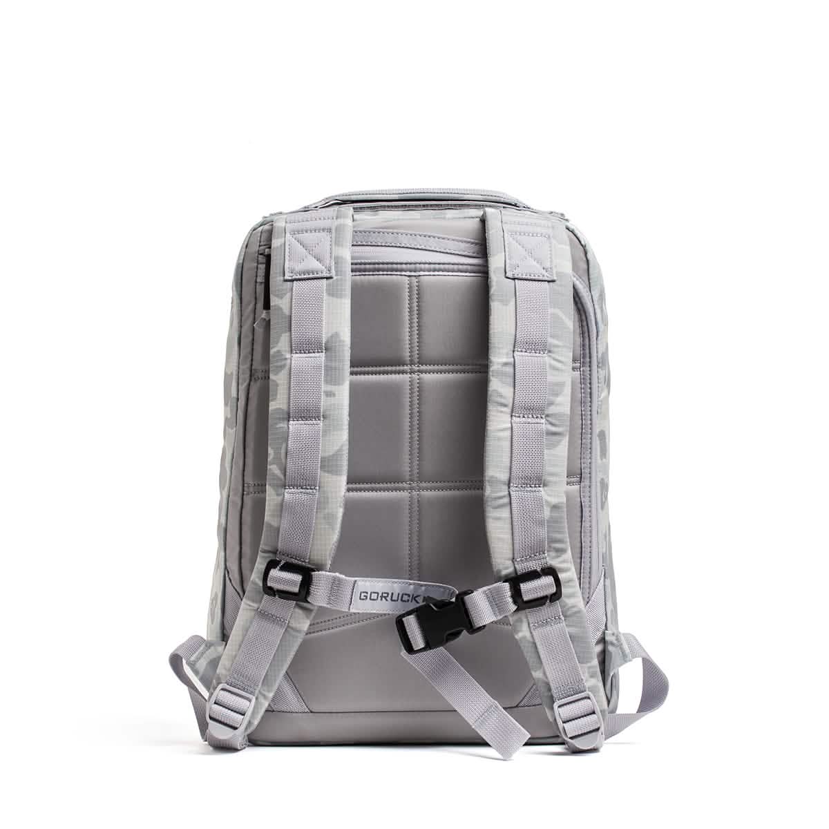 The GR0 - Ripstop ROBIC® is a light gray, water-resistant backpack shown from the back with padded straps and a sternum strap. This minimalist everyday carry is displayed against a white background.