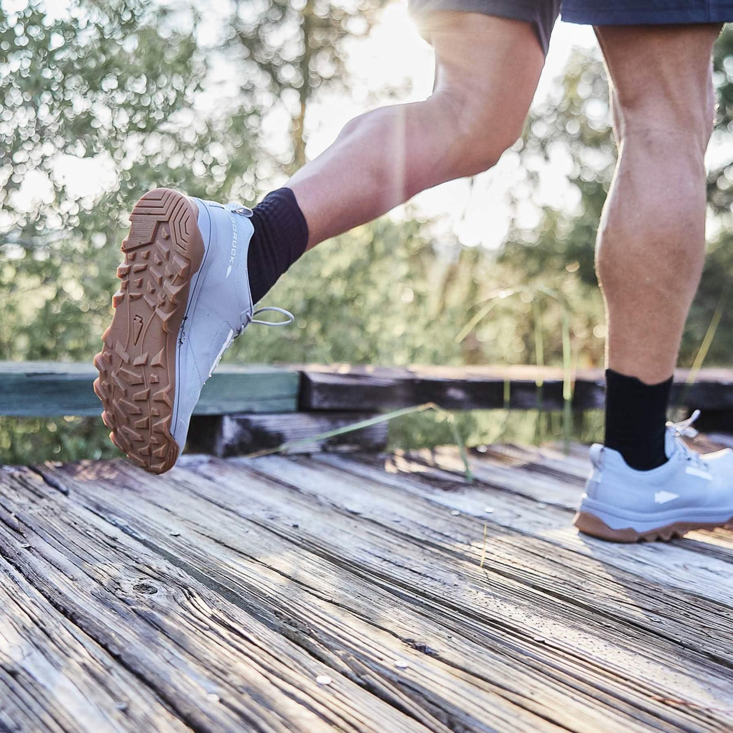 GORUCK rucking shoes on athlete running outdoors on weathered wooden path