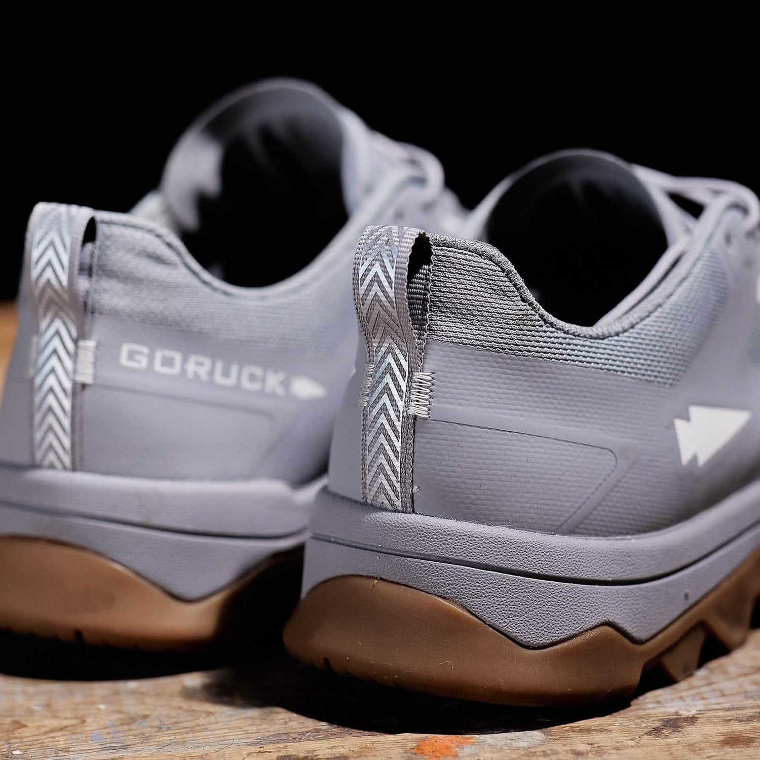 GORUCK chiseled stone grey rucking shoes with rugged soles on wooden surface