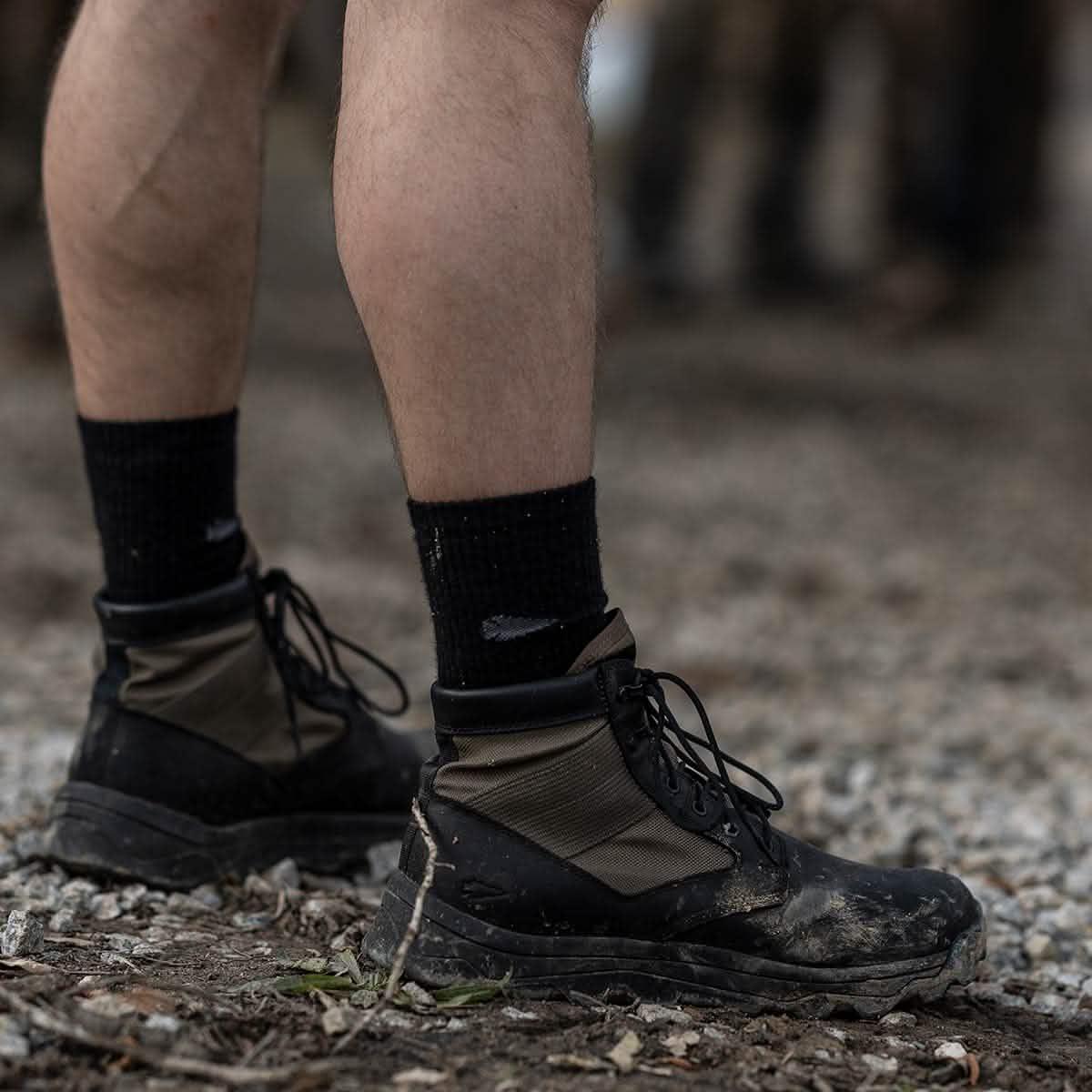 Close-up of GORUCK rucking boots on gravel, showing durable gear for outdoor training.