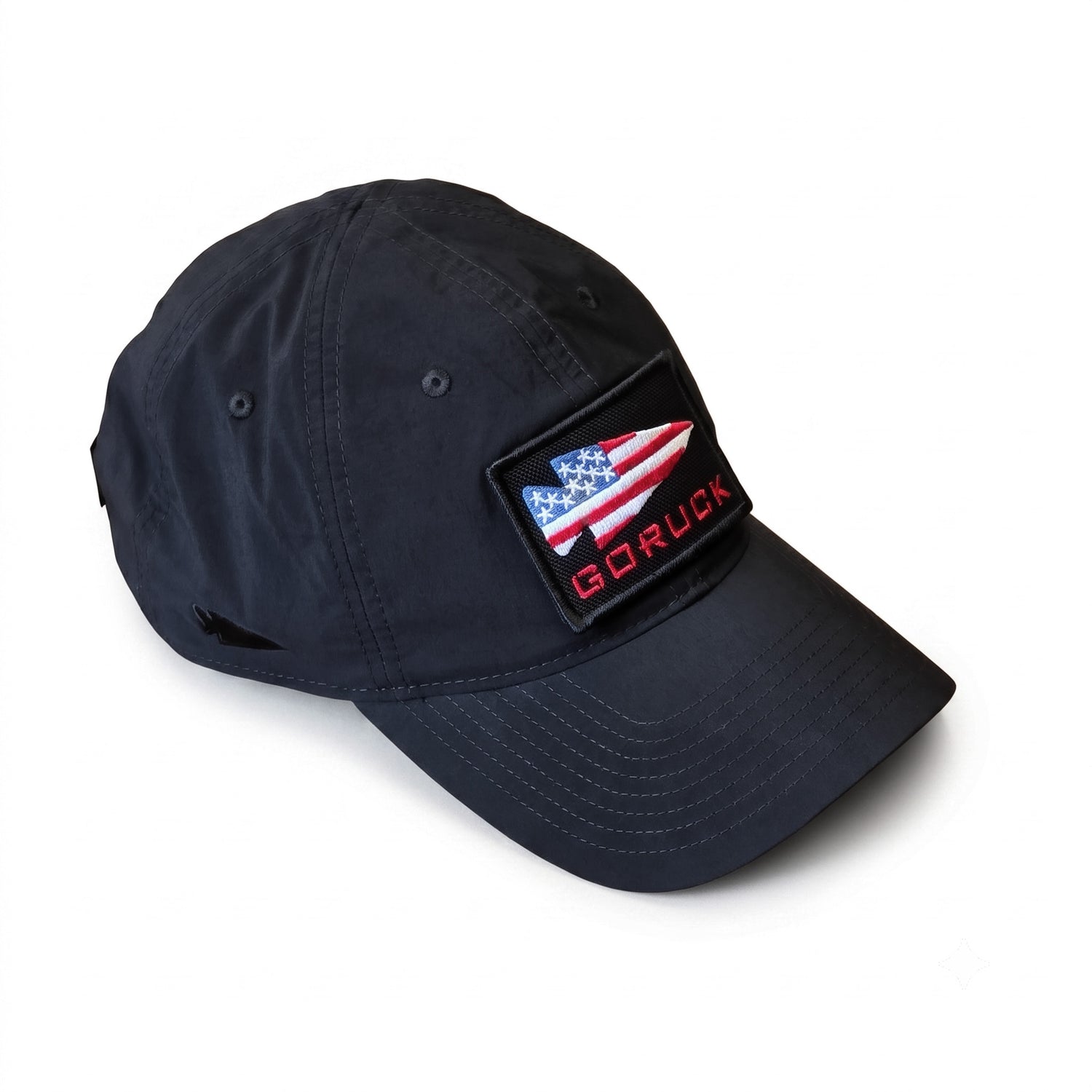 Navy blue Performance TAC Hat - TOUGHDRY by GORUCK, featuring an American flag arrow patch and crafted from durable ToughDry fabric, displayed on a white background.