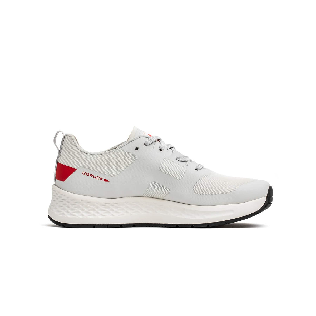 The Men's Rough Runner - Light Grey + Red is a lightweight running shoe with red accents, a textured white sole, and a Gradient Density EVA midsole for extra comfort—ideal for everyday wear.