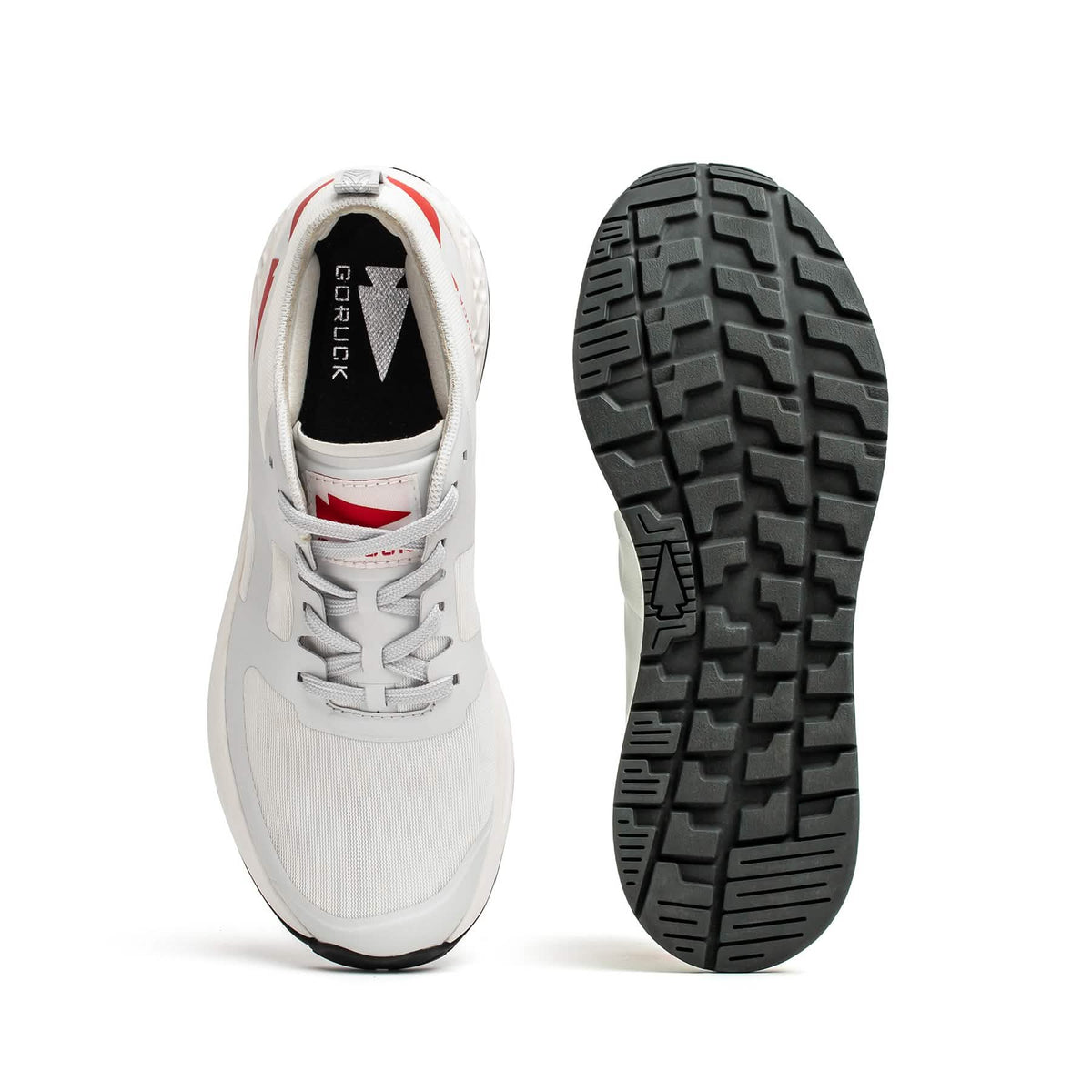 Top and bottom views of the Men's Rough Runner - Light Grey + Red, an athletic shoe featuring white and red accents, a textured black sole, and a Gradient Density EVA midsole for lightweight running performance.