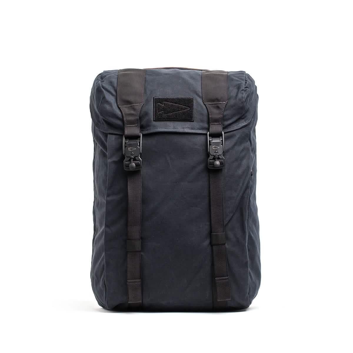 GORUCK waxed black rucksack with dual front buckle straps and arrow logo on top flap