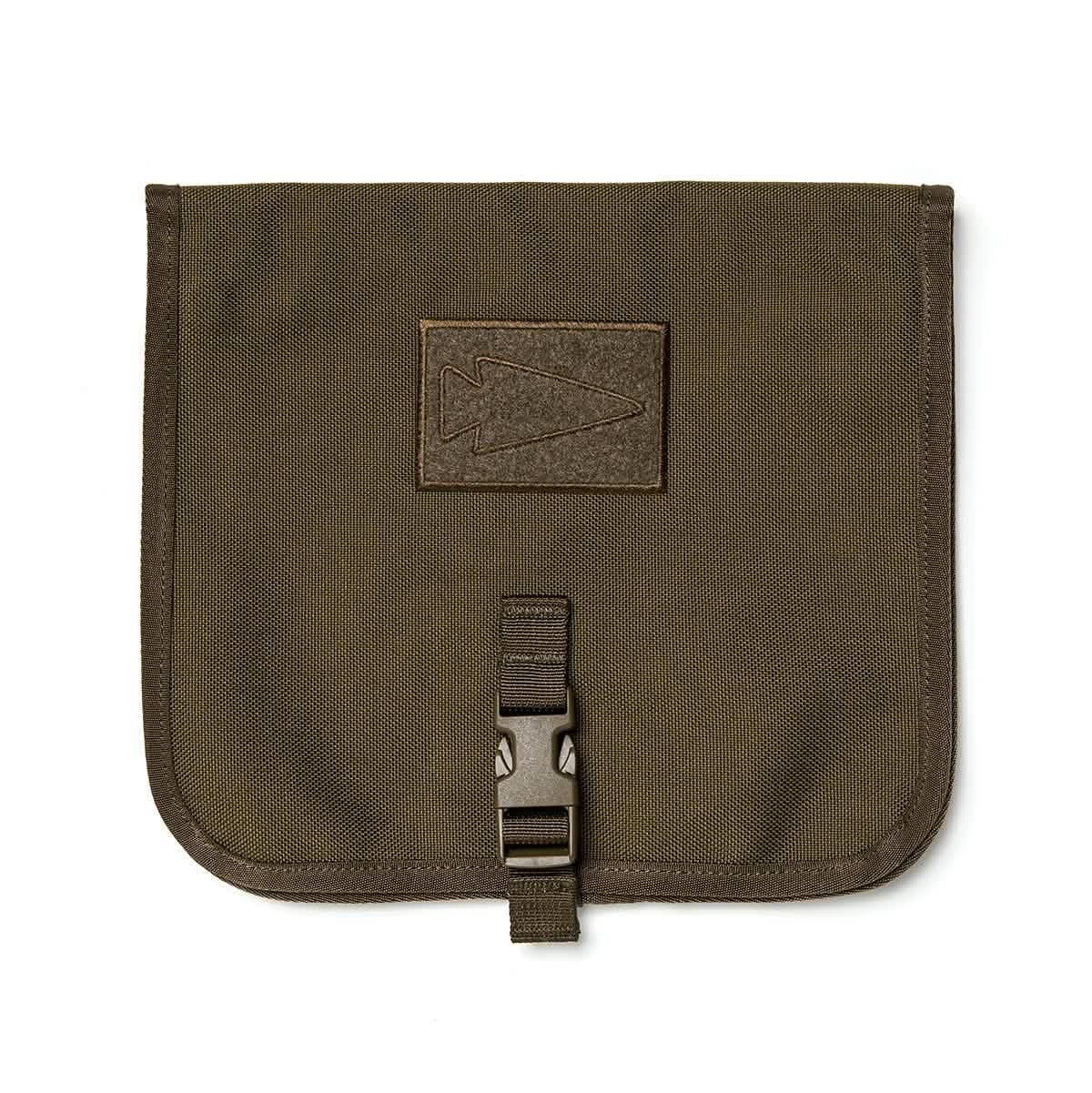 The Wire Dopp by GORUCK is a brown fabric pouch with a flap closure, designed for organized carrying of your travel essentials. It showcases a stitched arrowhead design on the front and is equipped with a durable CORDURA buckle clasp at the bottom.