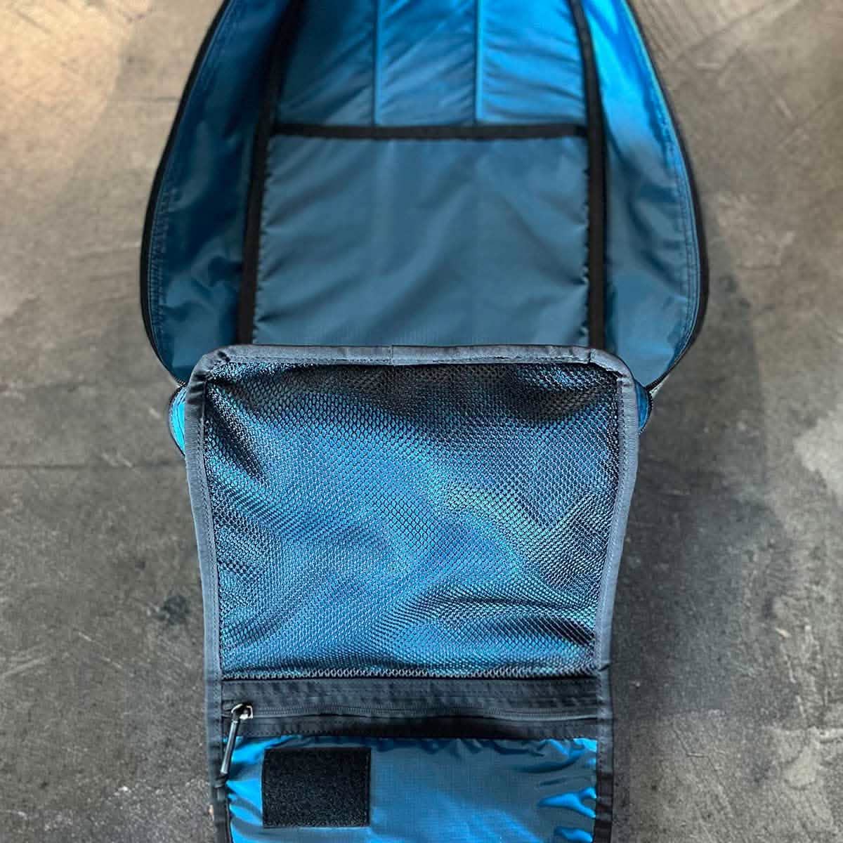 A rugged Bullet 15L Robic Nylon from GORUCK, crafted for durability by SCARS, lies flat on a textured surface, showcasing its spacious main compartment and practical mesh pocket.