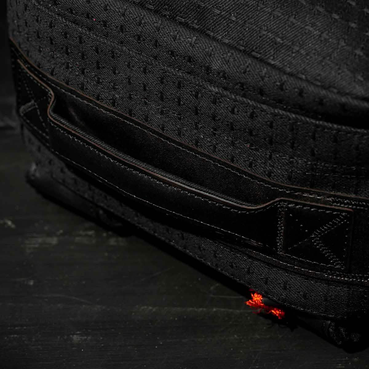 Close-up of a black Japanese cotton fabric bag featuring a stitched handle and small orange thread detail, part of the GR1 USA x Carryology - GRXC2 Samurai collection.