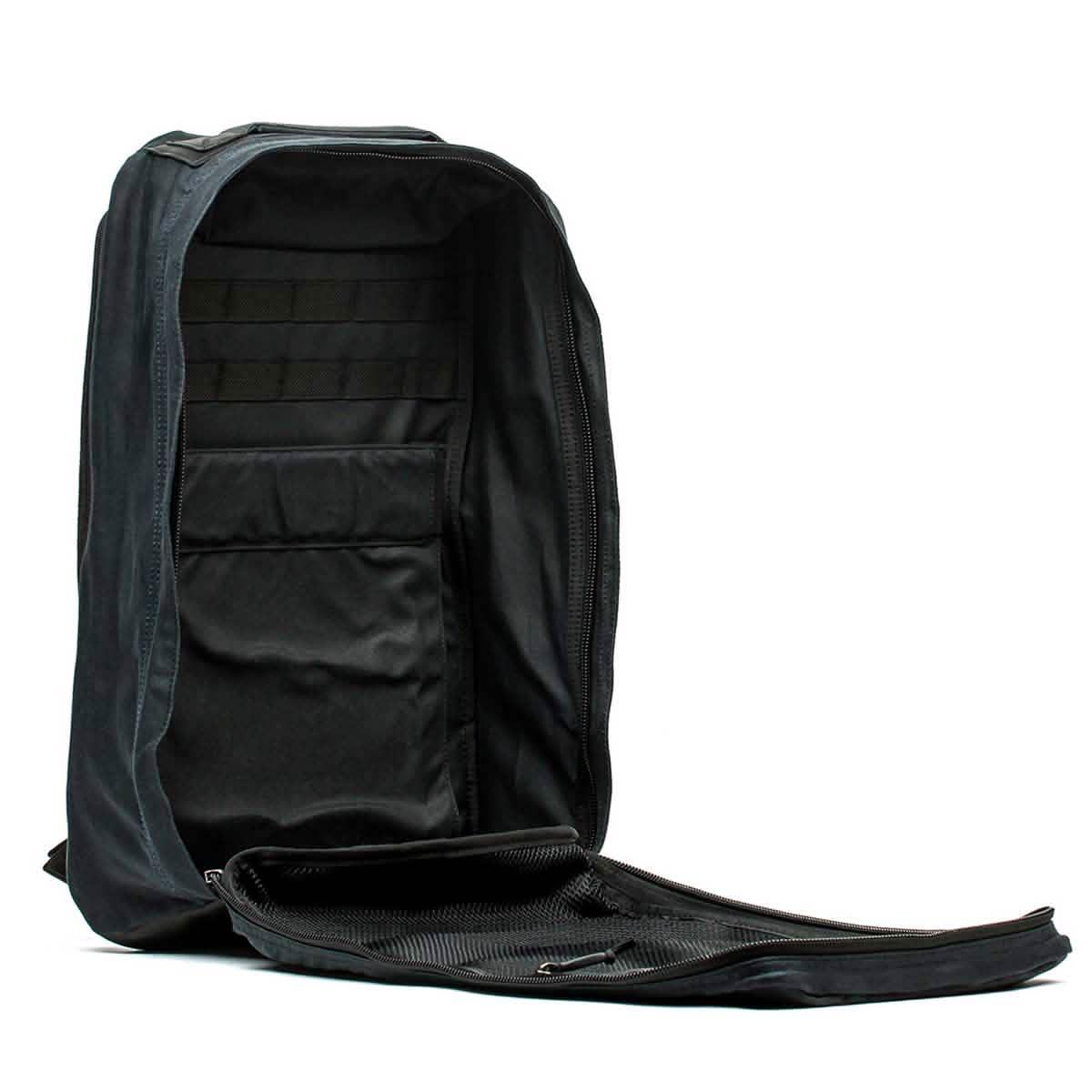 Open black tactical rucksack with multiple compartments and durable fabric for rugged rucking gear