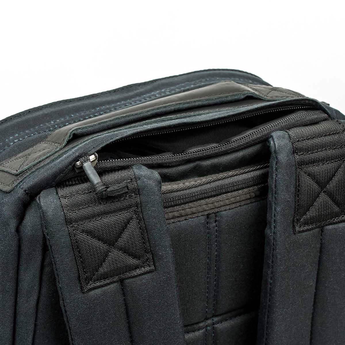 Close-up of black GORUCK backpack with padded shoulder straps and top zipper pocket detail