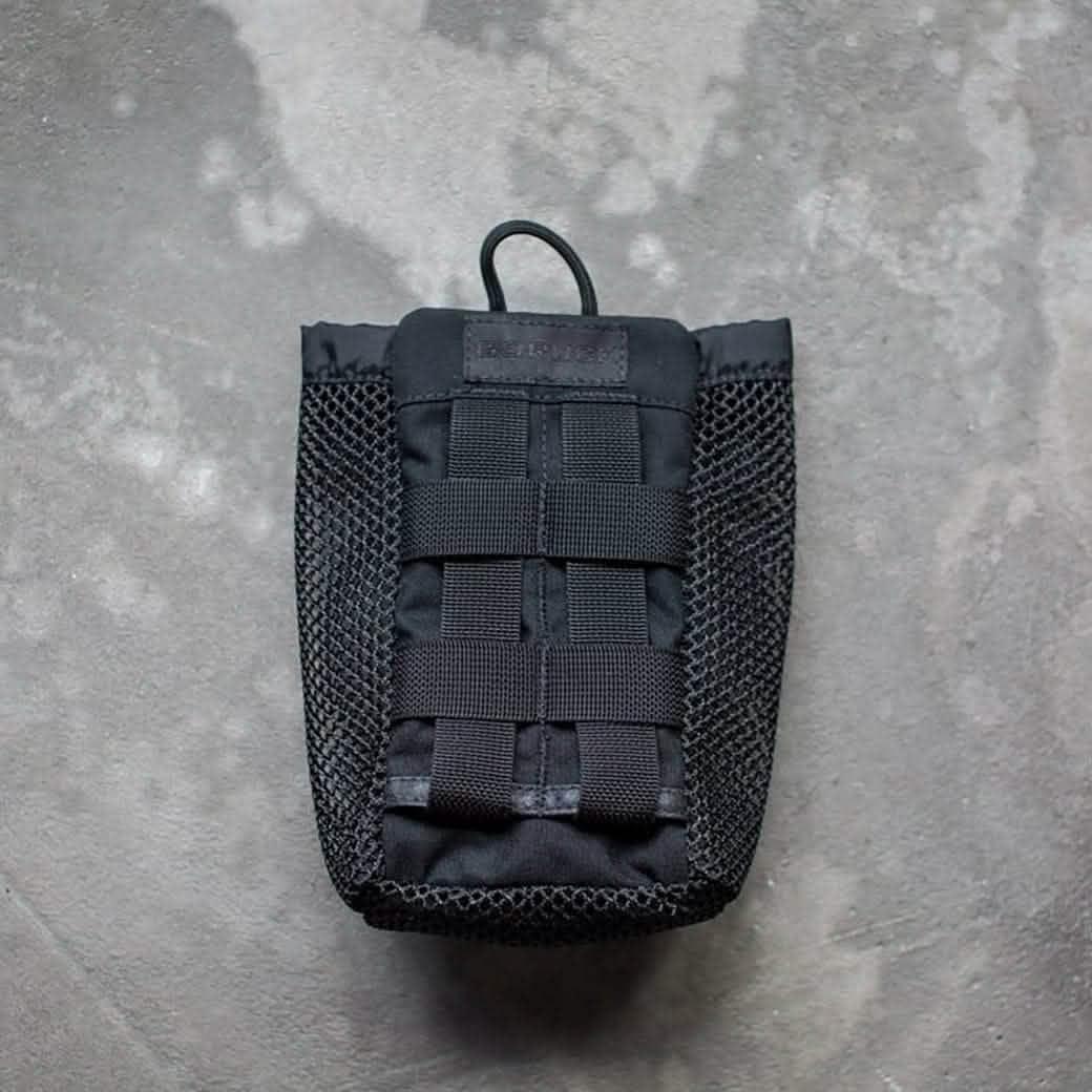GORUCK black tactical mesh pouch with MOLLE webbing on concrete background