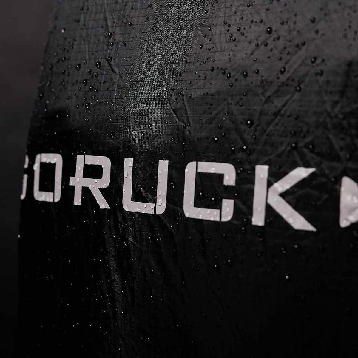 Close-up of black GORUCK gear with water droplets showcasing durable, water-resistant fabric