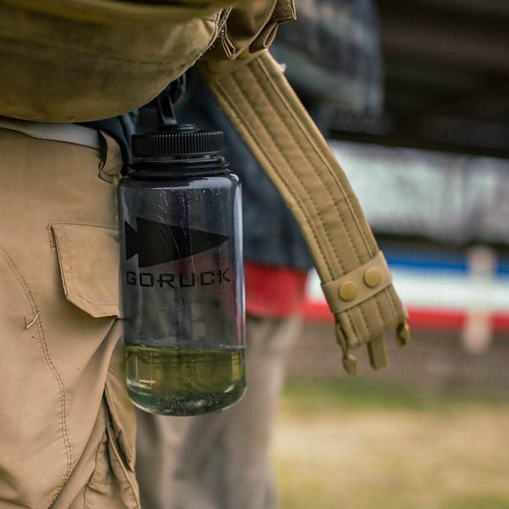 GORUCK water bottle clipped to khaki pants with rucksack strap, outdoor rucking gear