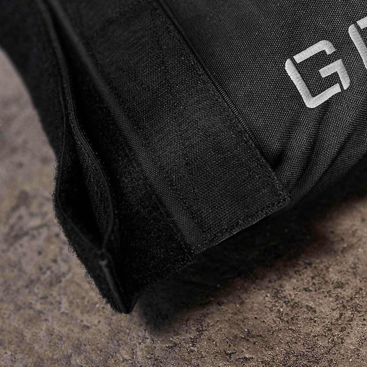 Close-up of GORUCK rucking gear with durable black fabric and Velcro on a concrete surface