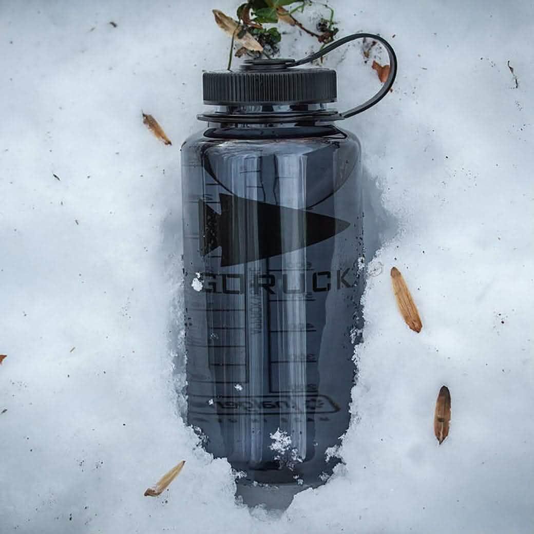 GORUCK black water bottle on snow, rugged outdoor gear for rucking and adventure