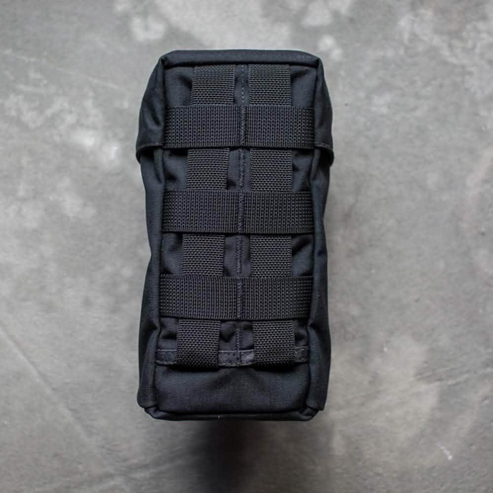 GORUCK black tactical water bottle pouch with MOLLE webbing on grey surface