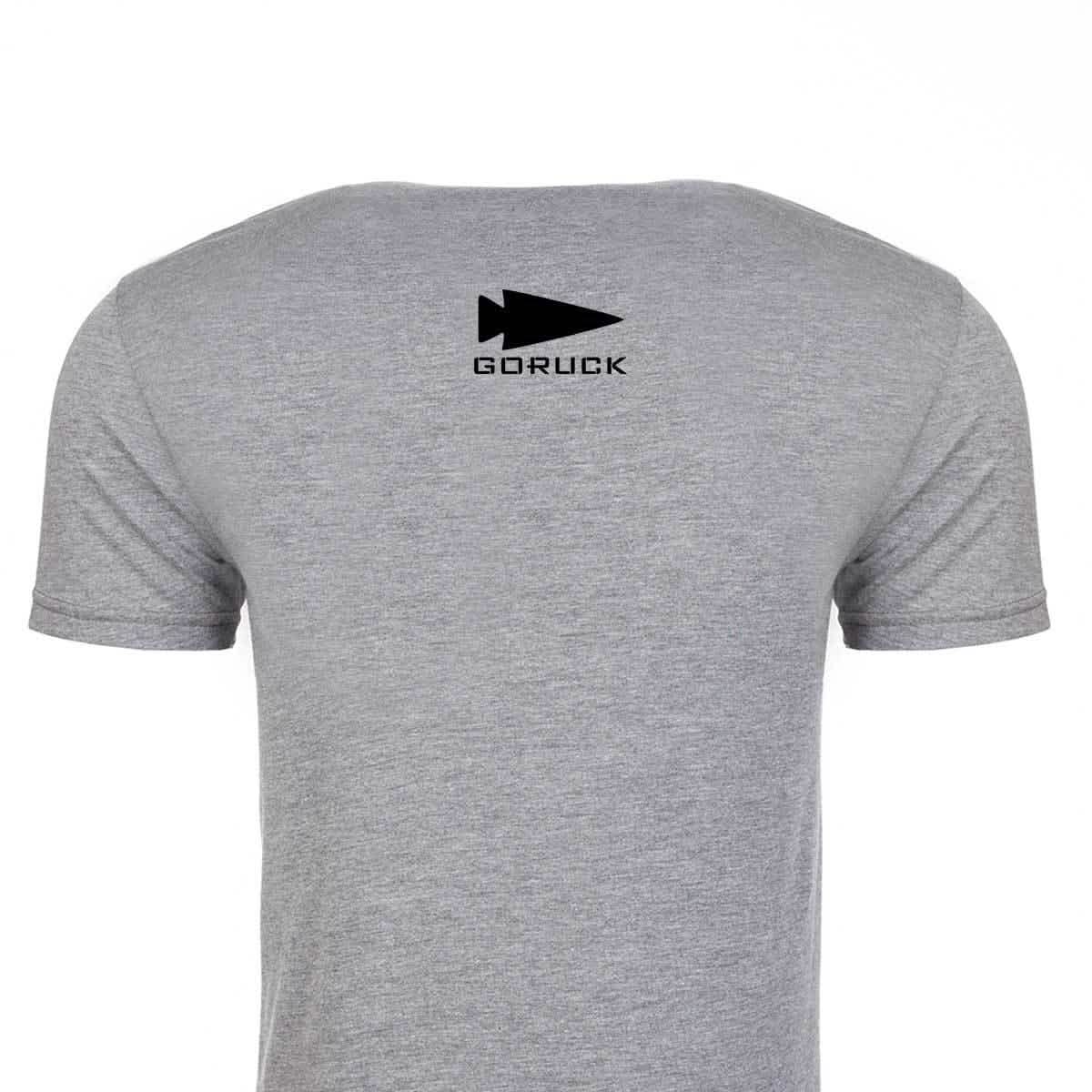 Rear view of the GORUCK USA Tee - Tri-blend by vendor-unknown, showcasing a black spearhead design near the collar on its premium gray tri-blend fabric.