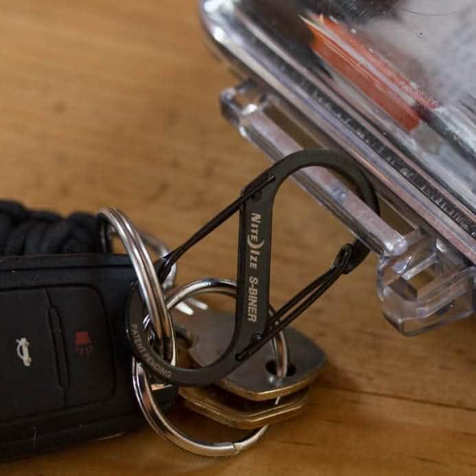 Nite Ize S-Biner keychain with keys and car fob on wood surface, GORUCK gear accessory