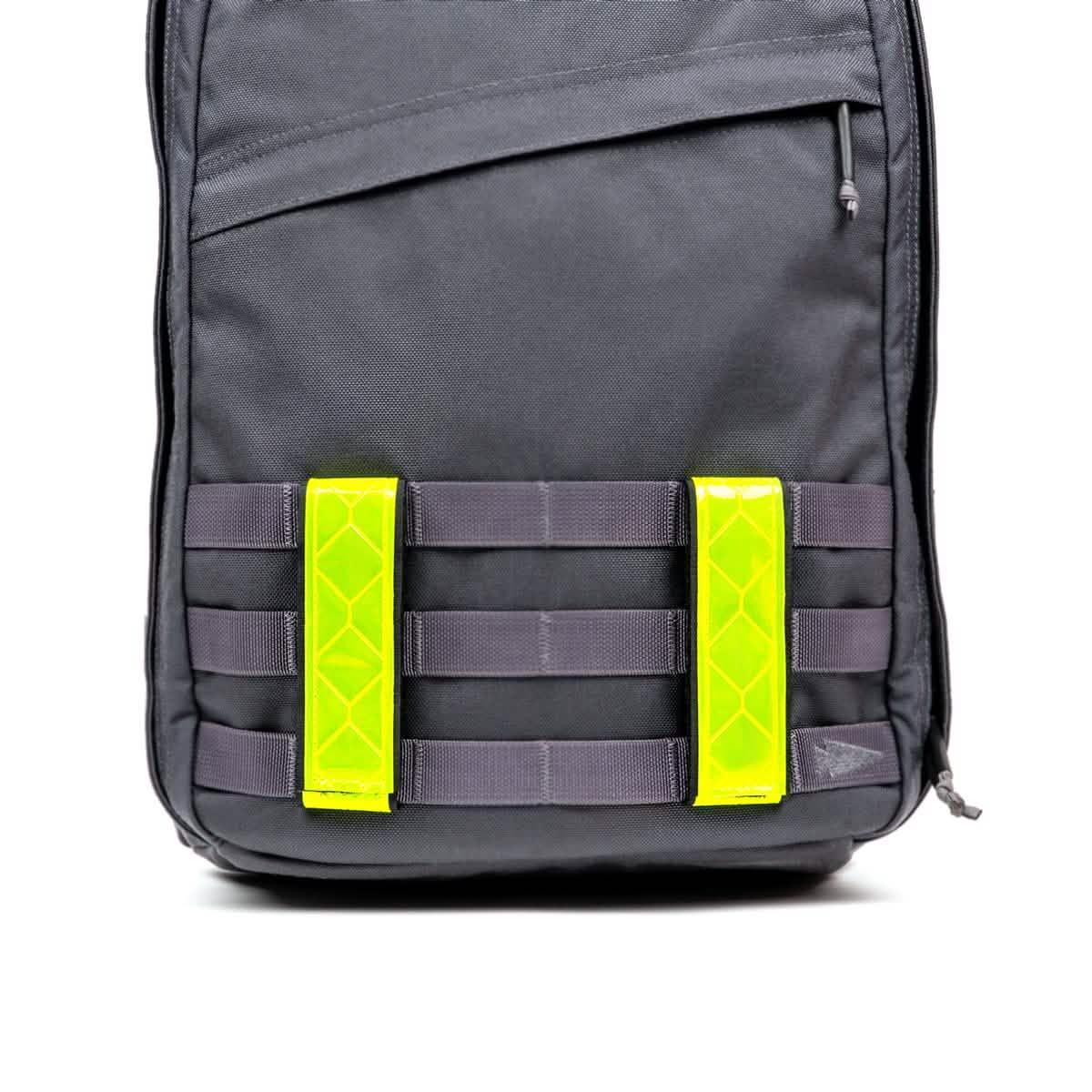 GORUCK black rucksack with high-visibility yellow reflective ruck bands attached