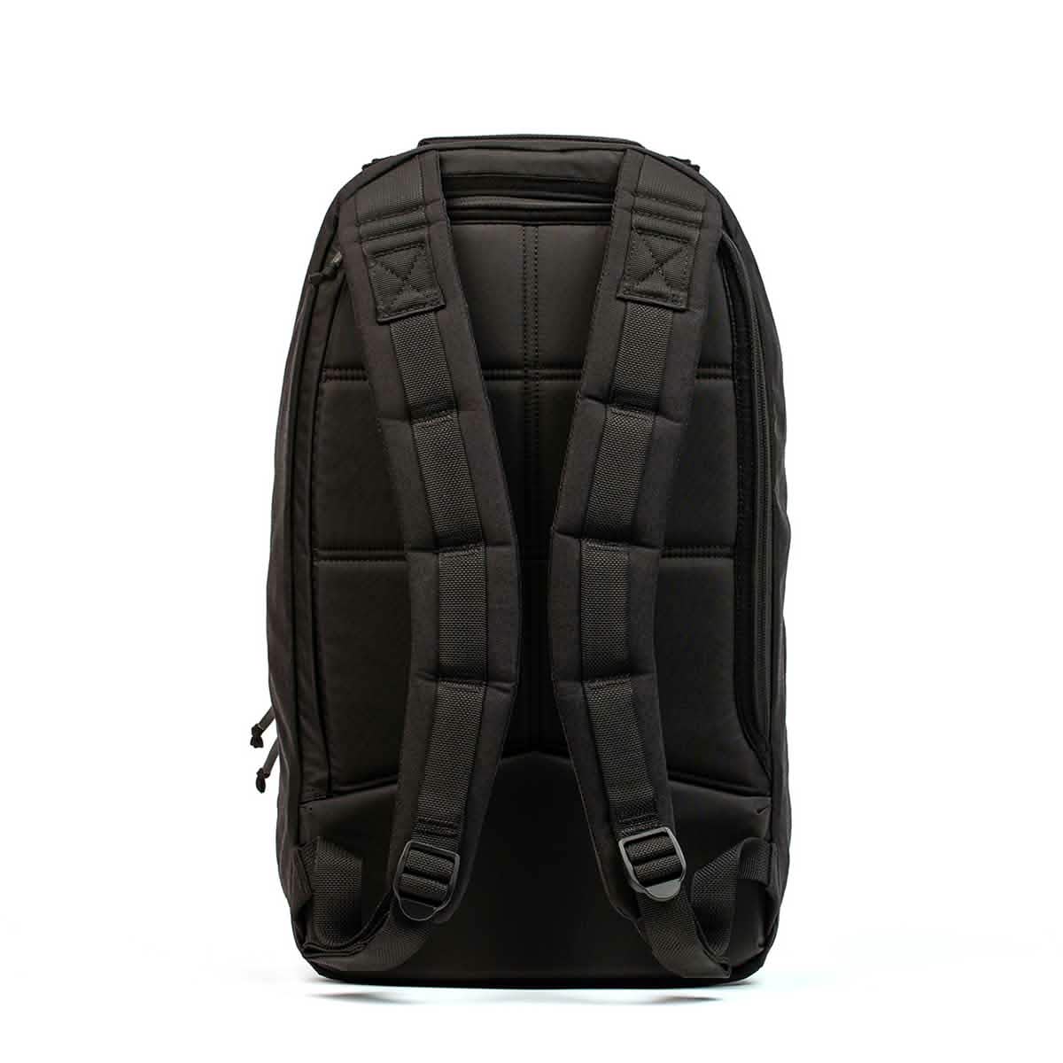 In the image, the Bullet Ruck Laptop - 16L by GORUCK is shown from the back, highlighting its padded shoulder straps and quilted design. It offers lumbar support for added comfort and stands upright against a white background, emphasizing its minimalist and functional style.