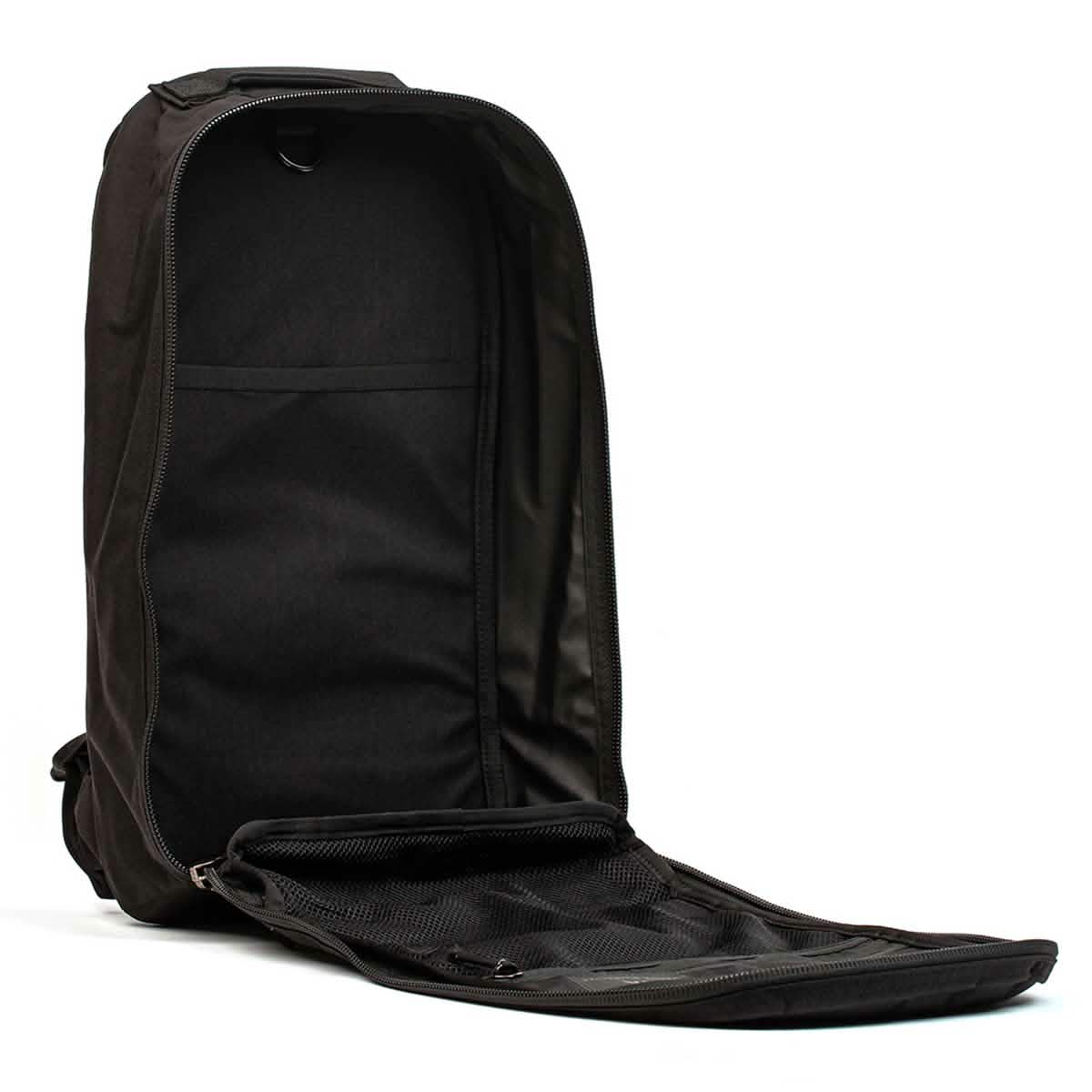 A GORUCK Bullet Ruck Laptop - 16L backpack in black, is shown with its main compartment open, showcasing a roomy interior. The unfolded flap reveals a zippered mesh pocket for organization, alongside a dedicated laptop compartment for secure storage and convenient access.