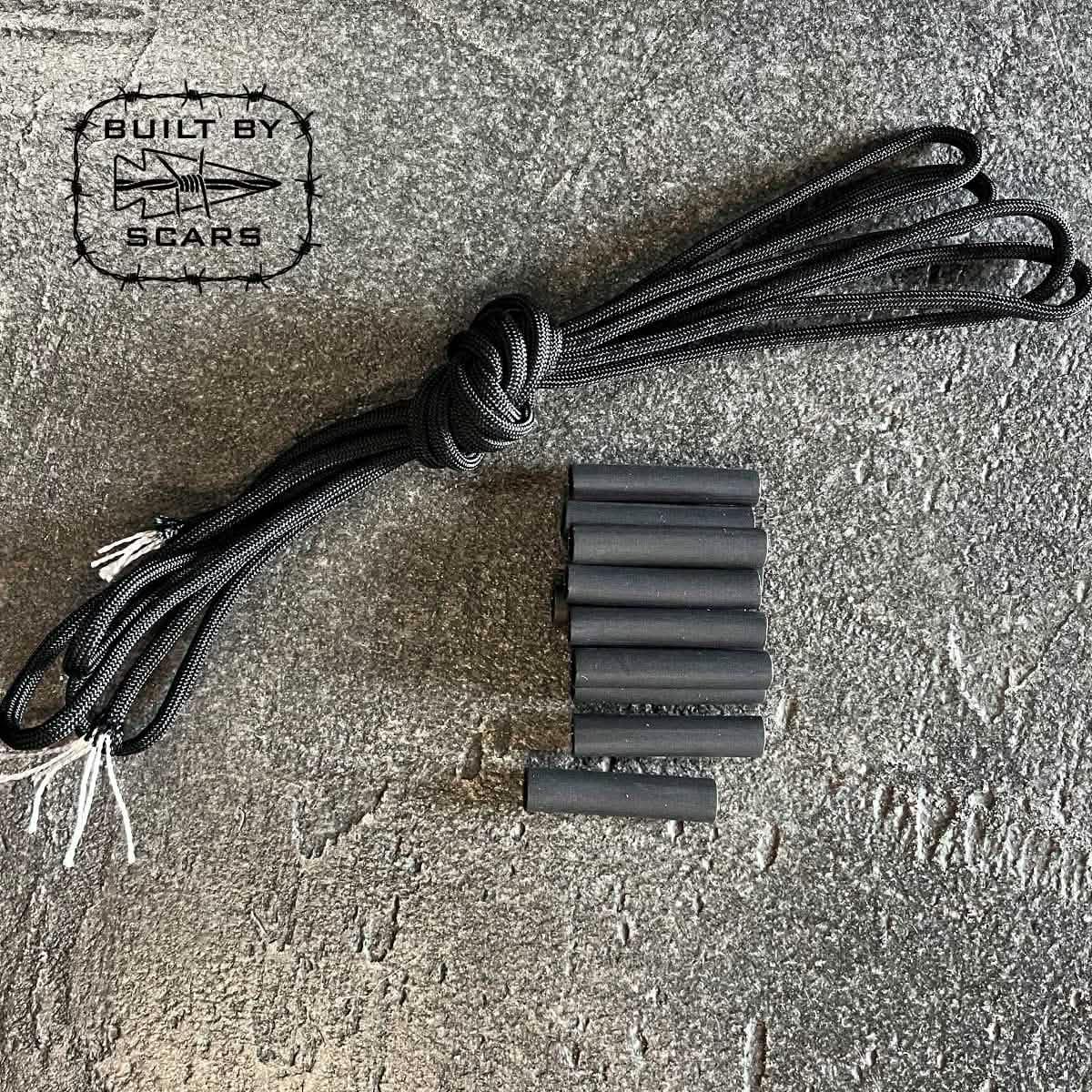Black durable cord bundle and black heat shrink tubes on textured surface with